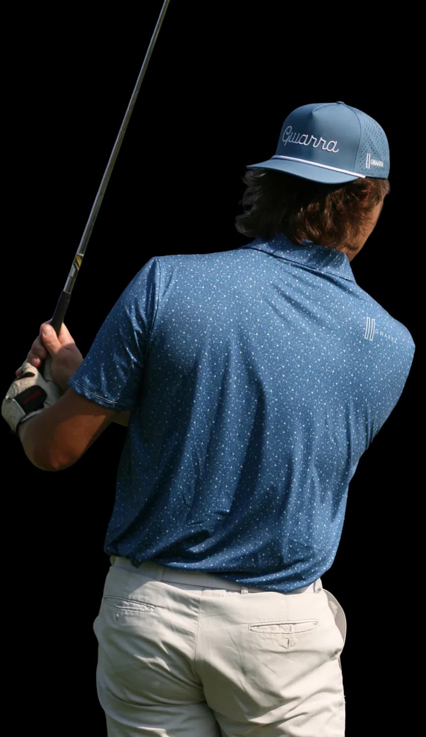 Golfer wearing a Gwarra performance polo mid-swing, facing the fairway